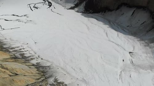 Drone view of frozen Gangapurna glacial moraine lake in winter in Manang Valley, Nepal.