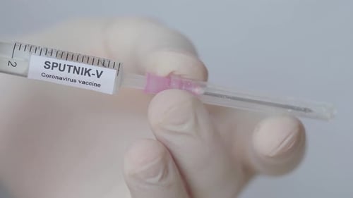 Sputnik V Against Coronavirus - Hand With Glove Attached Needle On Syringe And Then Removed The Cove