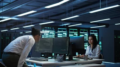 IT Professional Checks AI Assisted Systems in Server Hub Using Computer Workstation