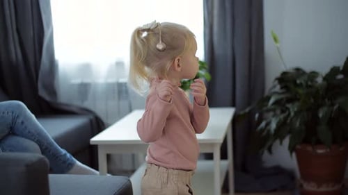 A Girl with a Cochlear Implant Watches TV and Hears Sounds