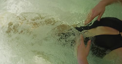 Close up of an young female is enjoying and having relax in a whirlpool bath tube in a luxury well