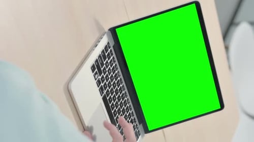 Vertical Video of Young Man Using Laptop with Green Screen