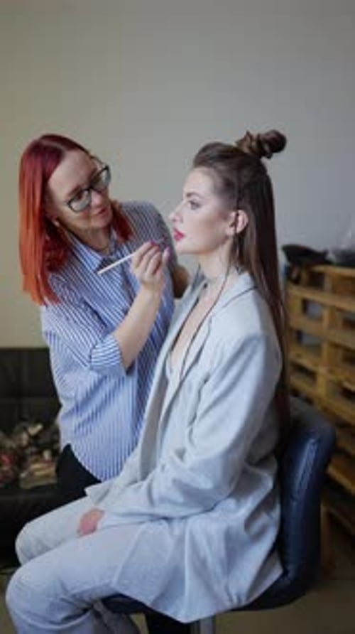 Makeup Artist Applies Makeup to a Glamorous Woman