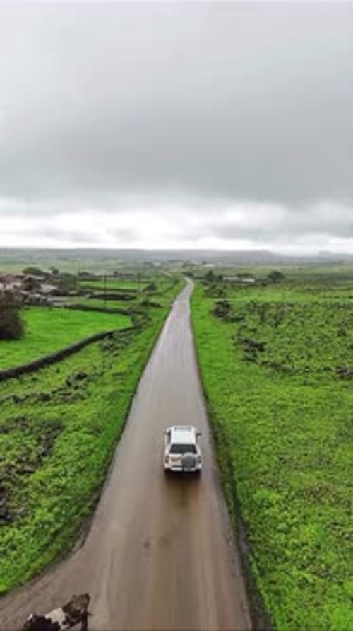 Aerial View of Car Driving on Country Road