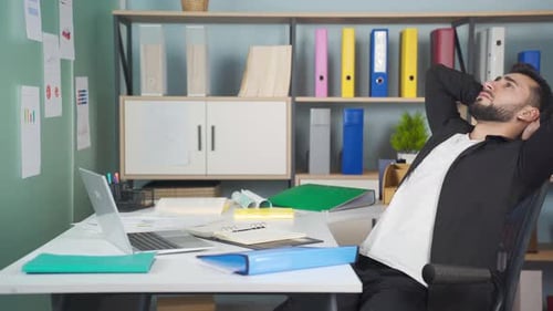 Man Feeling Stressed While Working at Desk