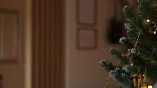 Side View of Happy Adorable Little Girl Enjoying Process of Decorating Christmas Tree at Home Cute