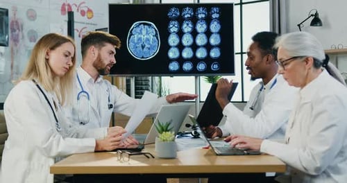 Medical Professionals Analyzing Brain Scan in Workplace