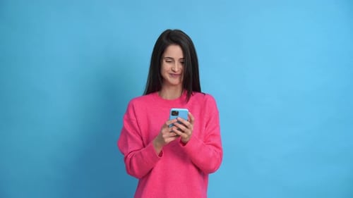 Young Woman with Smartphone in Studio