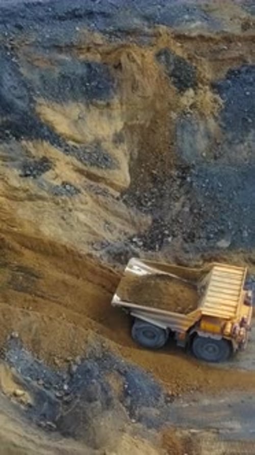 An Aerial View Capturing Heavy Mining Equipment Actively Engaged in Various Operations Stock Clip