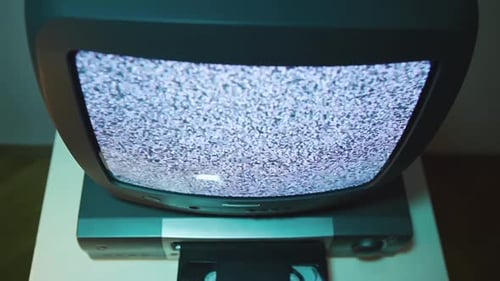 Top View Old TV and Video recorderVCS Cassette Being Inserted Into the Player