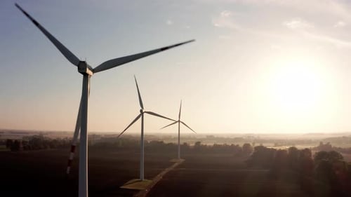 Aerial View of Wind Turbines on a Beautiful Field at Sunrise
