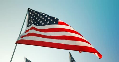 American Flag Waving against Blue Sky