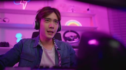 Young Adult Gamer Playing Video Games at Night