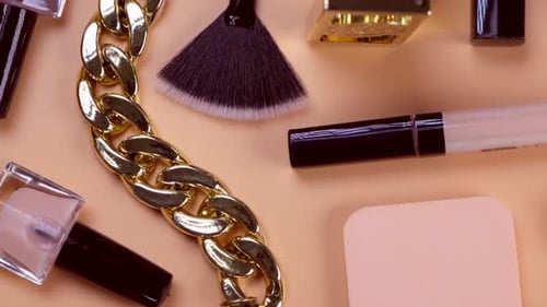 Rotating Background with Decorative Cosmetics and Bijouterie Chain Bracelet and Earrings or Clips or