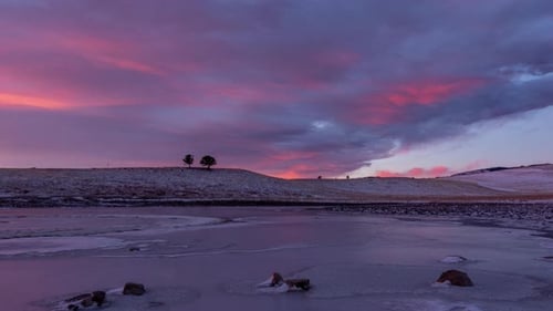 Time lapse of sunrise over a frozen lake