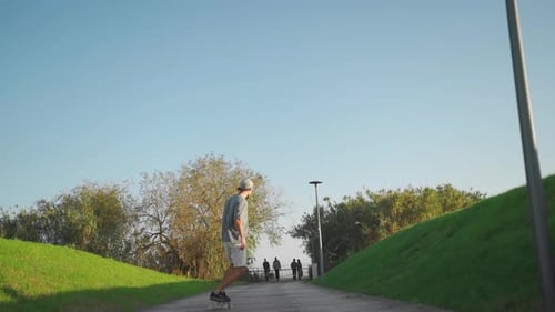 Man Ride Skateboard in Park Summer Day