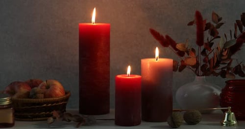 Burning Holiday Candles with Autumnal Decoration Still Life