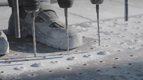Construction Workers Using Drilling Equipment for Building Foundations