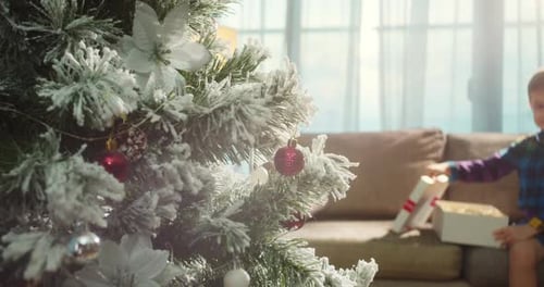 Young Boy Opening a Christmas Gift at Home