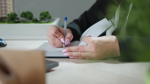 Close Up of Woman Writing in Professional Office