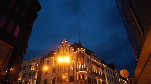 An Historic Building is Beautifully Illuminated at Dusk Within a Vibrant Urban Setting and