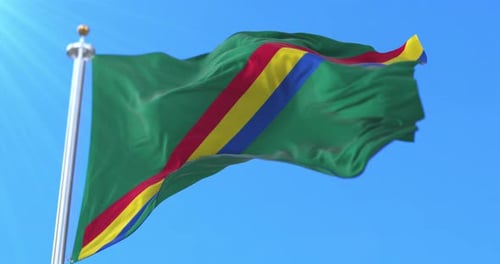 Realistic Waving Green Flag with Diagonal Red Yellow Blue Stripes