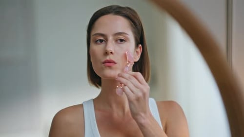 Woman Uses Facial Roller for Beauty Treatment