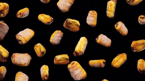 Realistic Chocolate Croissants Falling Seamlessly on Black Background