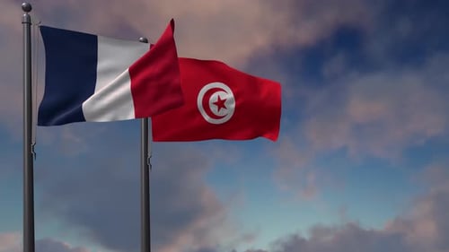 Flags of France and Tunisia Waving in the Sky