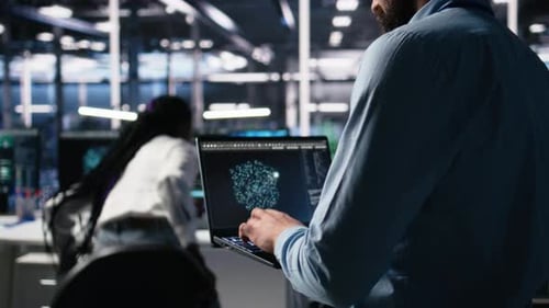Data Center Programmer Using Laptop to Monitor Neural Network Using AI Chatbot