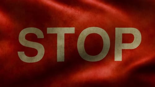Fluttering Flag with the Word STOP on the Worn Fabric