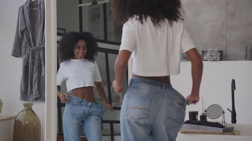 Woman Shows Weight Loss Success with Baggy Jeans