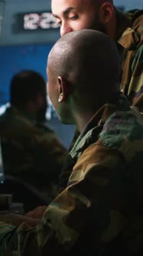 Soldiers Monitoring Computers in Dark Command Center