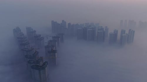 A city that seems to be floating in the air with fog and dust.