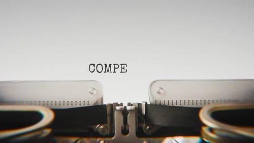 Old mechanical typewriter typing Competitor Analysis in a close-up view.