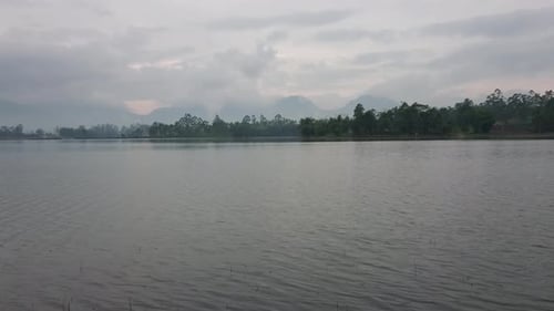 Foggy morning on a lake during sunrise. Misty landscape on a mountain lake. Peaceful environment sce
