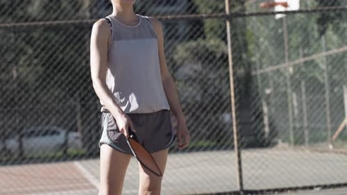 Woman Playing Pickleball Game Hitting Pickleball Yellow Ball with Paddle Outdoor Sport Leisure