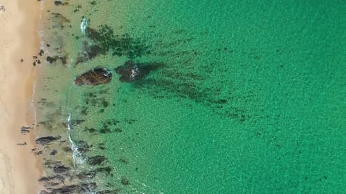 Aerial shot of sandy beach and tropical turquoise sea waves