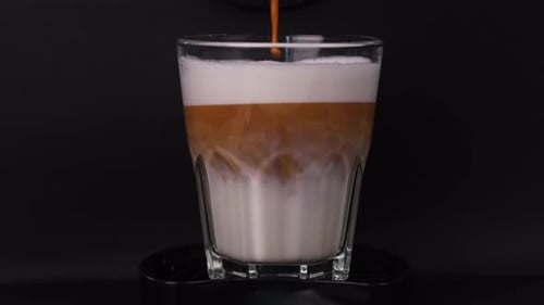 Espresso Poured into Milk for Layered Cafe Latte