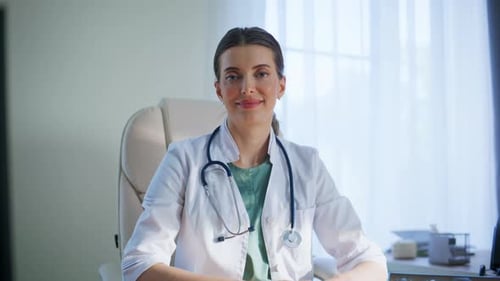 Smiling Doctor Looking Camera at Table at Clinic Portrait Closeup Woman Posing
