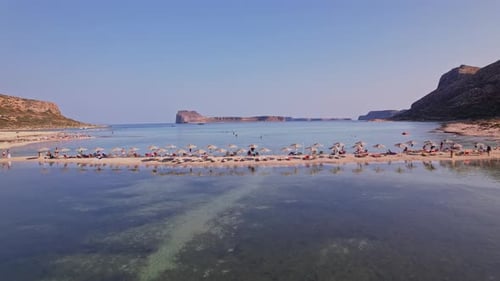Beautiful tranquil beach with umbrellas and clear waters in Crete