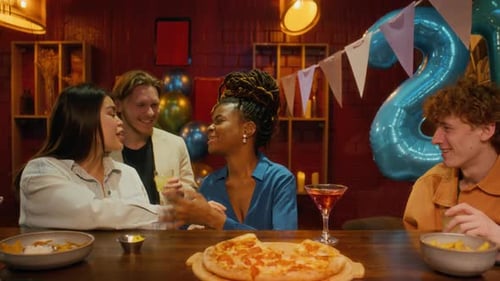 Four People Toasting with Glasses, Celebrating Birthday at Bar counter