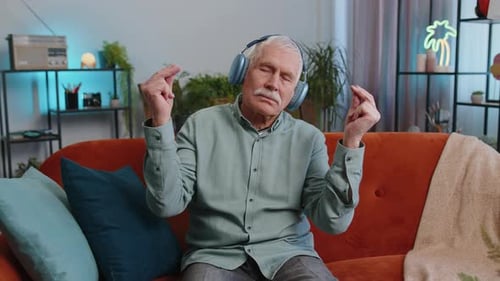 Senior Man Listening to Music on Couch
