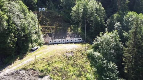Targets at outdoor shooting range close to strandaelvi river in Voss Norway - Sunny day aerial movin