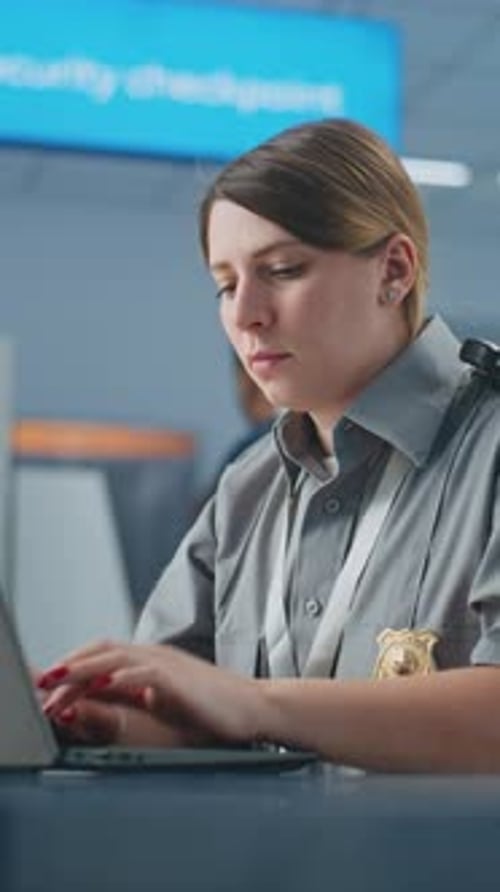 Airport Security Female TSA Officer Using Laptop Smiling and Looking at Camera