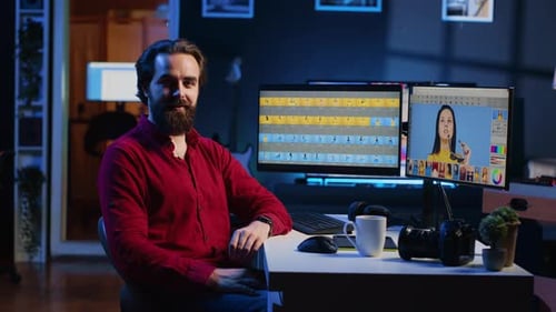 Bearded Man Waving in Dimly Lit Studio