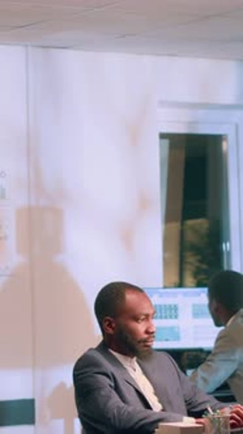 Vertical Video Employees Analysing Data Charts