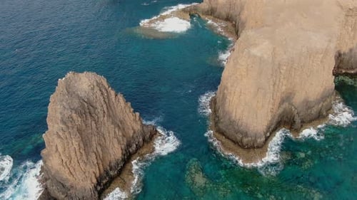 Aerial View of Rugged Cliffs and Ocean Coastline