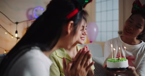 Young Adults Celebrating Birthday with Cake Indoors