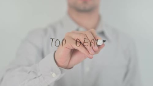 Man Writes "Top Deals" on Clear Surface